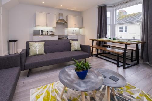 a living room with a couch and a table at Beautiful Central Apartment in Brighton & Hove