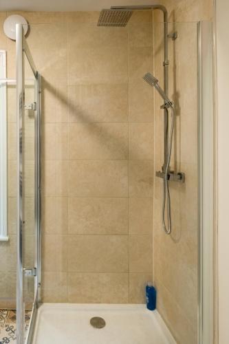 a bathroom with a shower with a glass door at Beautiful Central Apartment in Brighton & Hove