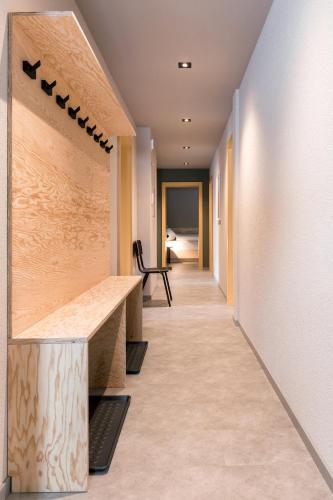 a corridor of an office building with a long hallway at Belmont- Apartment Haus in Arosa