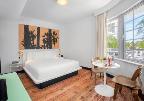 a hotel room with a bed and a table at AxelBeach Miami South Beach - Adults Only in Miami Beach