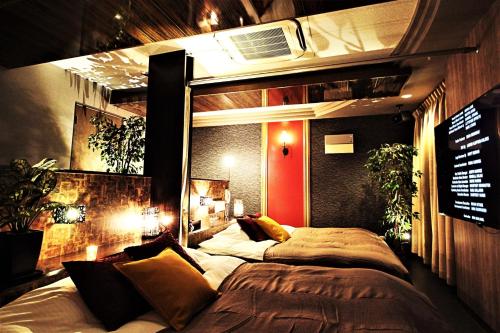 a bedroom with two beds in it with lights at HOTEL O2 -Adult Only- in Hirabari