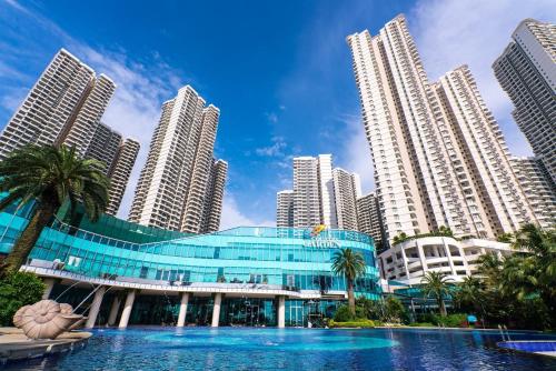 a building in front of a city with tall buildings at Country Garden Seaview Suite by Nest Home at Danga Bay in Johor Bahru