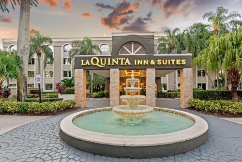 a fountain in front of a building at La Quinta by Wyndham Coral Springs South in Coral Springs