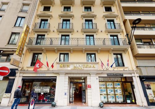a man standing in front of a building at Sun Riviera Hotel in Cannes