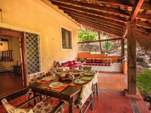 a dining room with a table and a patio at Villa Caribeña in Las Galeras