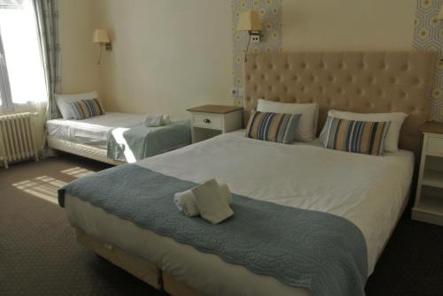 a hotel room with two beds in a room at Logis Hôtel Louise de Savoie in Blois