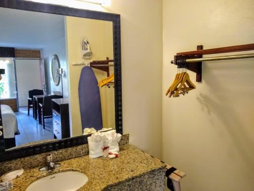 a bathroom with a sink and a mirror at Red Carpet Inn Airport Fort Lauderdale in Fort Lauderdale