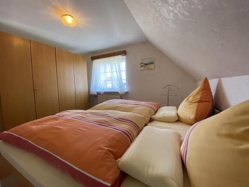 a bedroom with two beds in a attic at Appartement Vermietung Jensen in Morsum