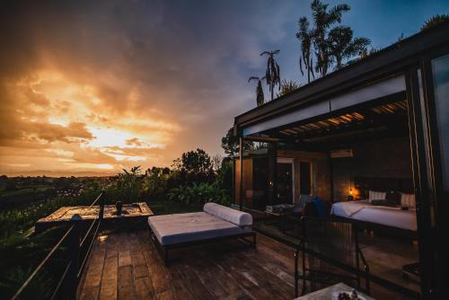 a room with a bed and a couch on a deck at Bio Habitat Hotel in Armenia