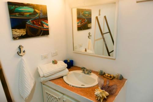 a bathroom with a sink and a mirror at Studio Lotte - Ocean Front in Las Galeras
