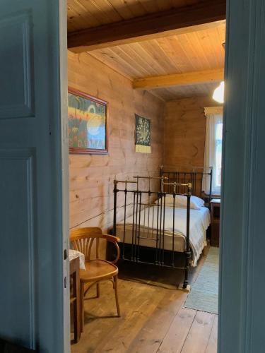 a bedroom with a bed in a room with wooden walls at INNA BAJKA in Nowy Berezów