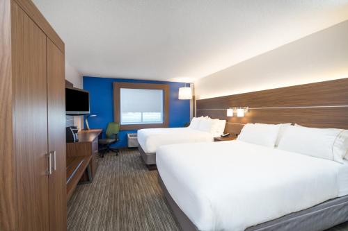 a hotel room with two beds and a television at Holiday Inn Express Hotel Howe / Sturgis by IHG in Howe