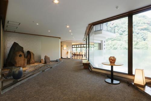 a room with a large window and a table at Hakoneji Kaiun in Hakone