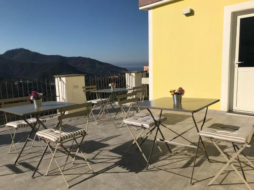 two tables and chairs on the balcony of a building at Agriturismo SanCristoforo in Levanto