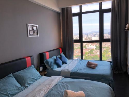 a bedroom with two beds and a large window at 28 Boulevard Studio Suite Resort Facilities 3-6KM to Velocity MyTown KLCC in Kuala Lumpur