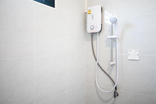 a shower in a white bathroom with a shower at INN MY PLACE in Pak Chong