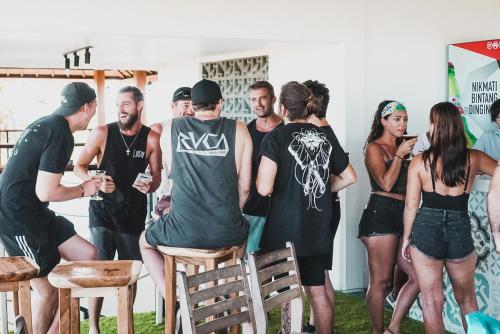 a group of people standing around in a room at Swell Hotel, Pool Bar & Restaurant in Tanah Lot