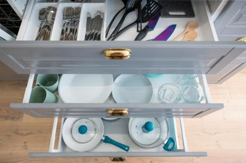 a drawer filled with dishes and other kitchen utensils at Flora Apartment Kosice Center in Košice