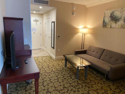 a living room with a couch and a tv at Holiday Inn El Monte - Los Angeles by IHG in El Monte