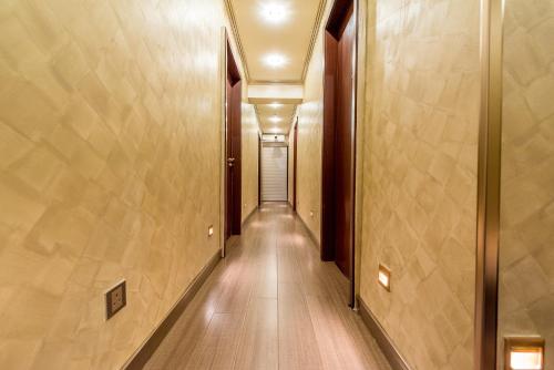 a hallway with a long corridor with wood floors and ceilings at CJ Residence - Opposite Public Bank Centre Point in Kota Kinabalu