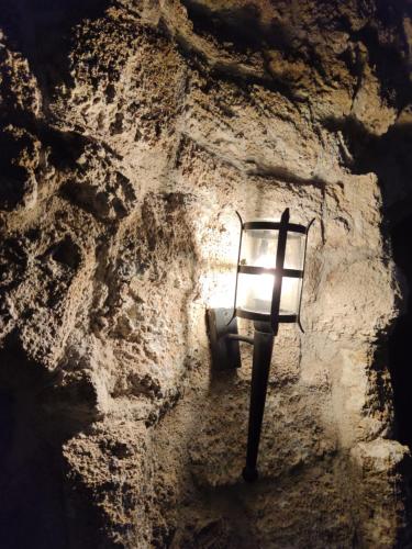 a light on the side of a stone wall at Porolithos Boutique Hotel in Rhodes Town