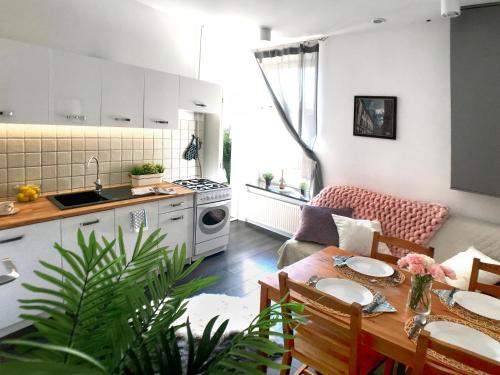 cocina y sala de estar con mesa y sillas en Apartament Peowiaków Queens en Lublin