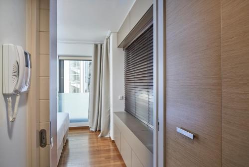 a bedroom with a window with a blind on it at Contemporary & Comfy Apt next to Acropolis Museum in Athens