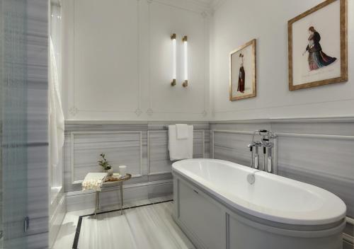 a bathroom with a tub, sink, mirror and bathtub at Six Senses Kocatas Mansions in Istanbul