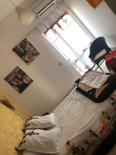 a bedroom with a bed in a room with a window at reda land in O Ben Slimane