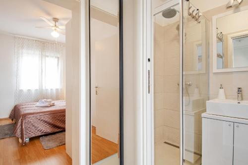 a bathroom with a shower and a sink at Rooms&Apartments Zelux in Split