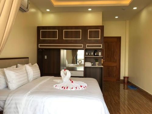 a bedroom with a bed with a towel on it at Winston Hotel Riverside in Ho Chi Minh City