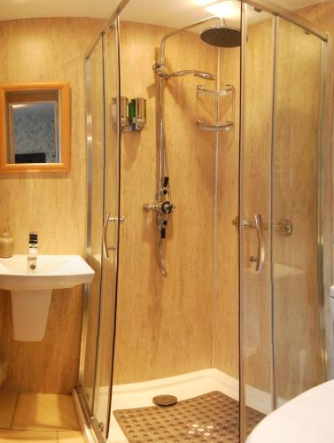a shower with a glass door in a bathroom at No9 Guesthouse in Hunstanton