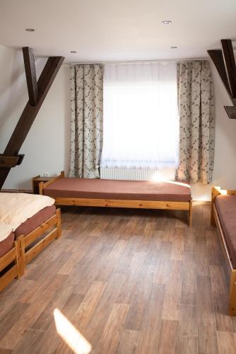 a bedroom with two beds and a window at Ubytování v soukromí in Dolní Bukovsko