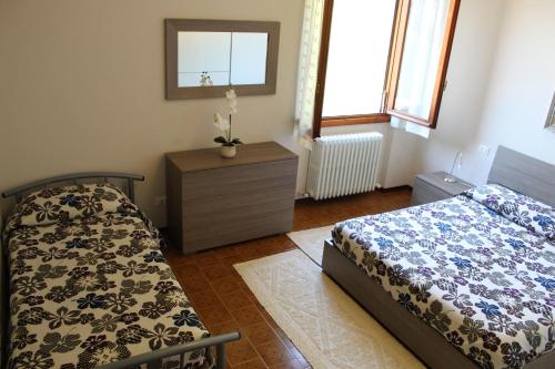 a bedroom with a bed and a dresser and a mirror at Residence Molinari Lake Como in Lezzeno