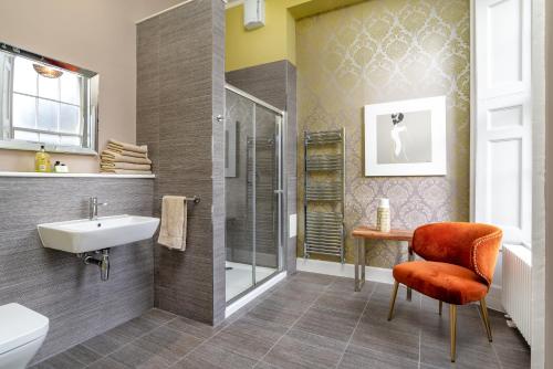 a bathroom with a shower and a sink and a toilet at Haymarket Apartments in Edinburgh