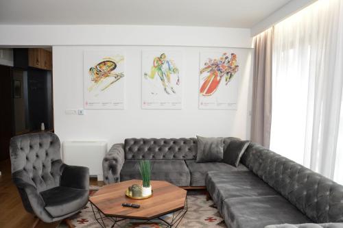 a living room with a leather couch and a table at OLYMPIC 84 Apartments in Sarajevo