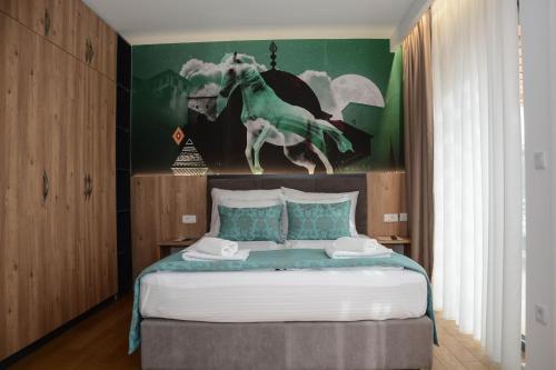 a bedroom with a bed with a painting of a horse at OLYMPIC 84 Apartments in Sarajevo