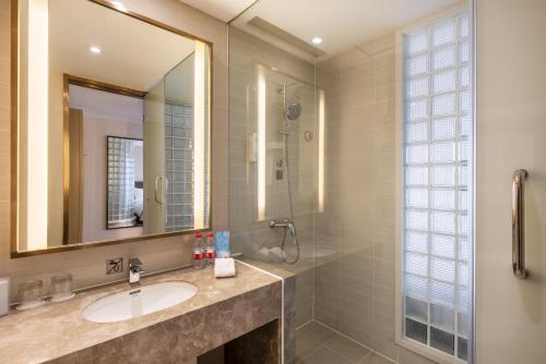 a bathroom with a sink and a mirror at Holiday Inn Express Shenyang Golden Corridor, an IHG Hotel in Shenyang