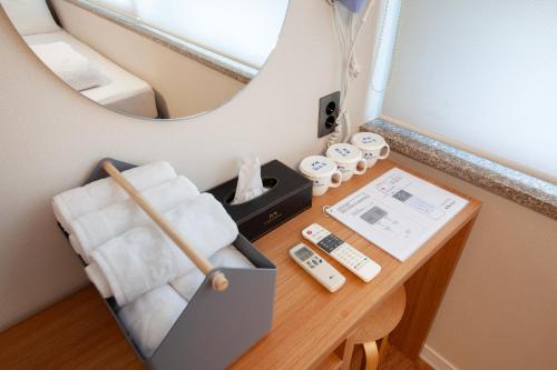 a table with a mirror and a chair in a room at K-Grand Hostel Dongdaemun in Seoul