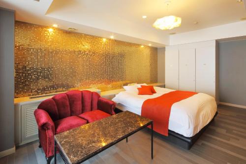 Postel nebo postele na pokoji v ubytování HOTEL ATLANTIS Otaru(Adult Only)