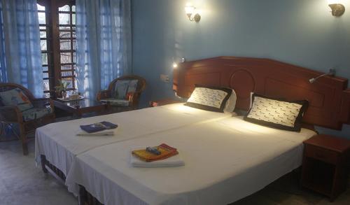 a bedroom with a large bed with two towels on it at Anitha's Garden Stay in Kovalam