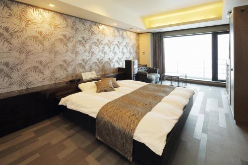 Postel nebo postele na pokoji v ubytování HOTEL ATLANTIS Otaru(Adult Only)
