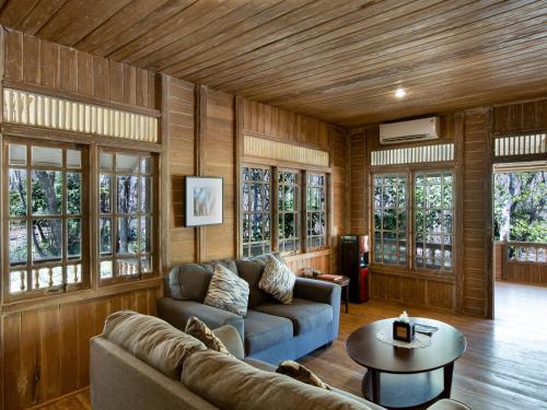 a living room with a couch and a table at Menjangan Ecolodge - CHSE Certified in Banyuwedang