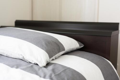 a close up of a bed with two pillows at Cocostay KO Residence Sennichimae#603ココステイ ケーオーレジデンス センニチマエ#603 in Okayama