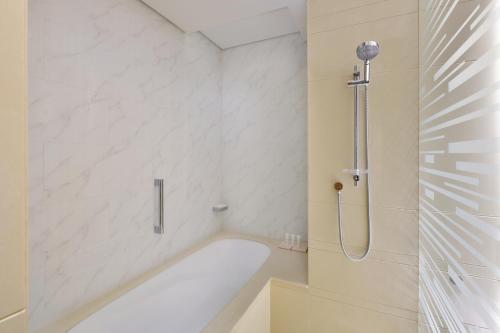 
a bathroom with a tub and a shower stall at Crowne Plaza Dubai Marina, an IHG Hotel in Dubai
