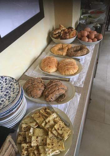 a buffet with several plates of food on a table at Casa Mespilea in Paphos City