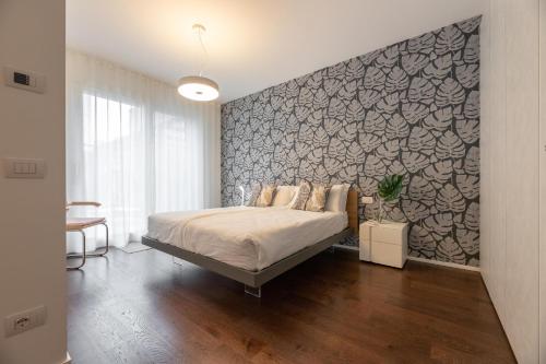 a bedroom with a bed and a large wall at Il Garovaglio in Como