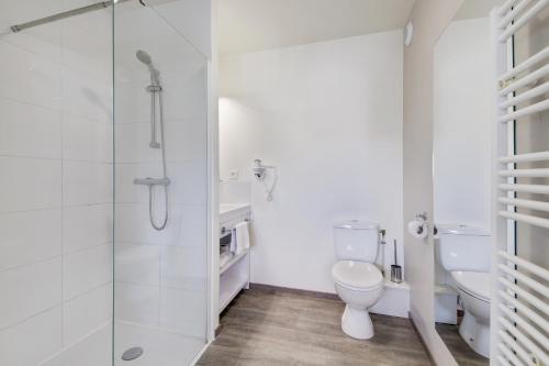a bathroom with a toilet and a shower at All Suites Appart Hôtel - Bordeaux - Pessac in Pessac