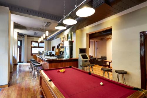 a pool table in a room with a bar at Hotel Sophia in Melbourne