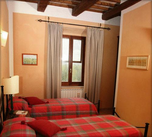 a bedroom with two beds and a window at Tenuta Saracone in Montalto di Castro